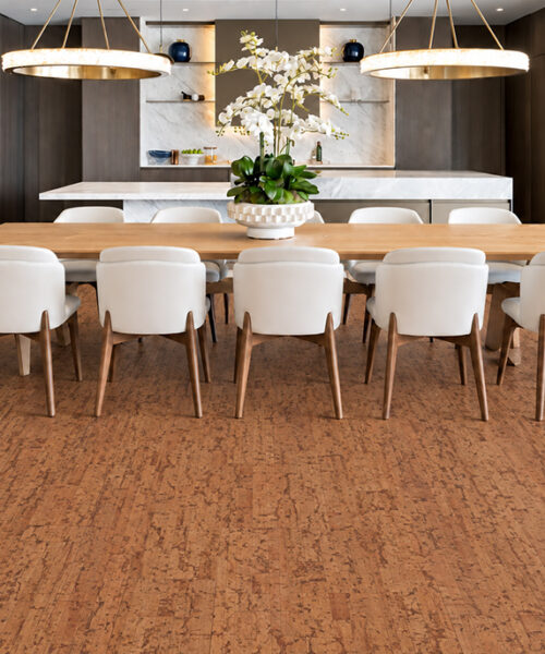 Amber Streak 12Mm Golden-Brown Floating Cork Flooring Spans An Elegant Kitchen-Dining Room With A Marble Island.