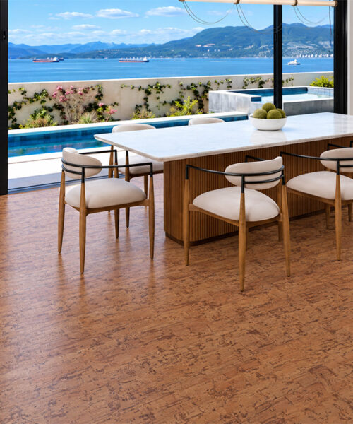 Warm-Brown Amber Streak Floating Cork Flooring Fills A Waterfront Dining Room With Pool And Mountain Views.