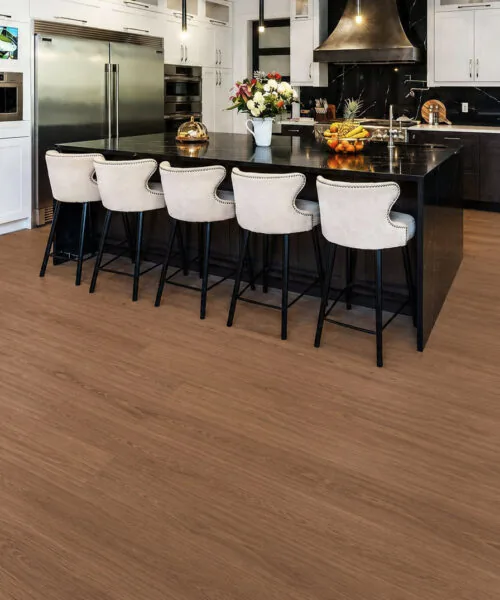 Wide-Plank American Red Oak Cork Flooring In A Large Modern Kitchen With White Cabinets
