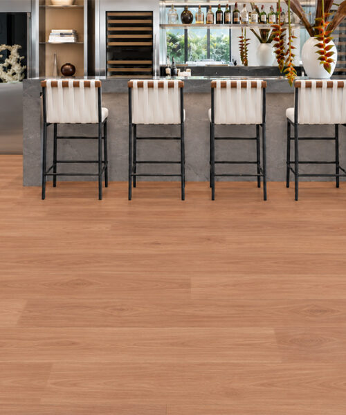 American Red Oak Wood-Look Cork Flooring Displays Subtle Oak Grain Beneath A Modern Bar And Upholstered Stools.