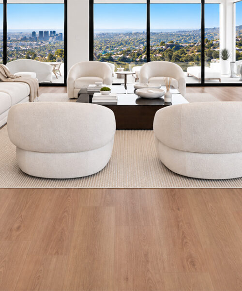 American Red Oak Sustainable Flooring Spans A City-View Living Room Furnished With White Sofas And Rounded Chairs.