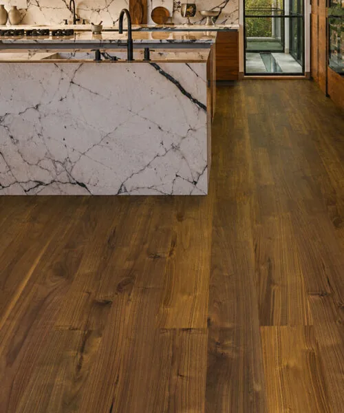 Ashen Chestnut - 7/16&Quot; (11Mm) - Swiss Design Cork Floating (Fascnut11) Ashen Chestnut 11Mm Cork Flooring In A Contemporary Kitchen With A Marble Island And Wood Cabinetry.