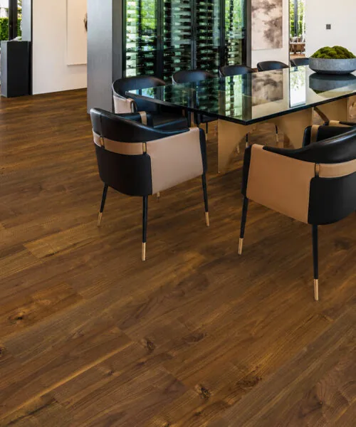 Ashen Chestnut Swiss Design cork floating flooring in a modern dining room with rich brown wood-look planks.