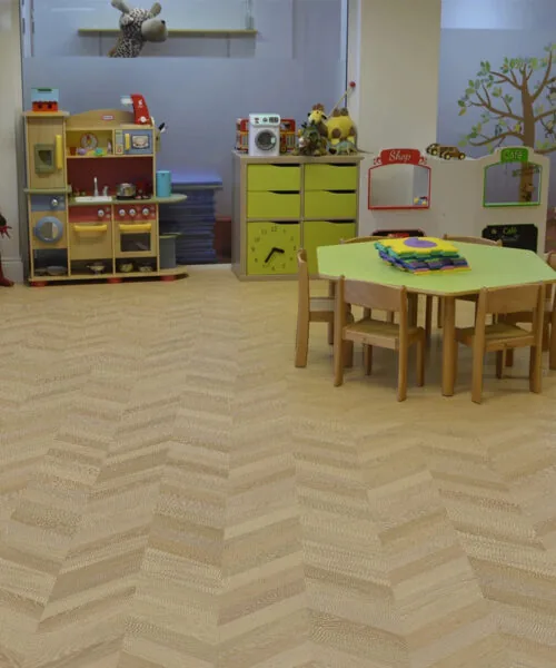 Aurora Chevron - 7/16″ (11Mm) - Swiss Design Cork Floating (Fauro11) Aurora Chevron Cork Flooring In A Daycare Classroom – Soft, Quiet, And Comfortable Surface Ideal For Children’s Play Areas.