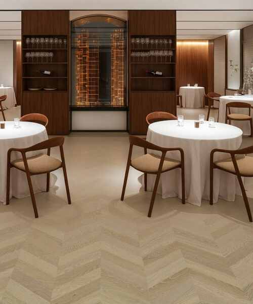 Elegant Aurora Chevron cork flooring in a modern restaurant – warm tone, acoustic comfort, and refined chevron pattern.