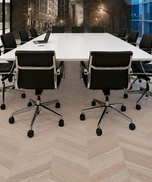 Aurora Chevron Commercial Cork Flooring Anchors A Glass-Walled Conference Room With Black Rolling Chairs.