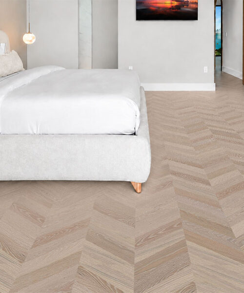 Aurora Chevron Comfortable Cork Flooring Forms A Light Gray Pattern Around A White Upholstered Bedroom Suite.