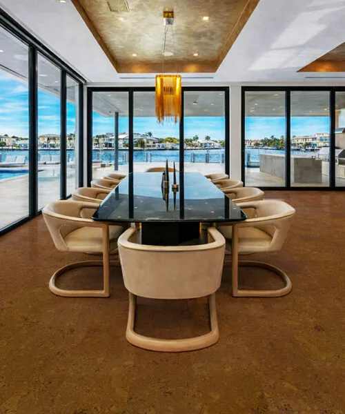 Autumn Ripple cork flooring complementing a luxury dining space with panoramic waterfront views