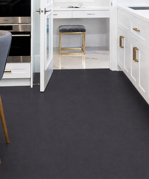 Comfortable Black Buffalo Real Leather Flooring In A White Luxury Kitchen With Matte Black Planks, Marble Island, Gray Bar Stools And Brass Hardware.