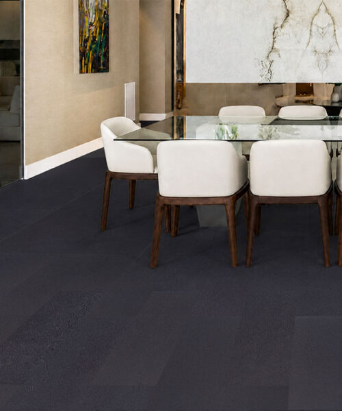 Black Buffalo Real Leather Flooring In A Contemporary Dining Room With Deep Black Planks, Glass Dining Table, White Chairs And Marble Feature Wall.
