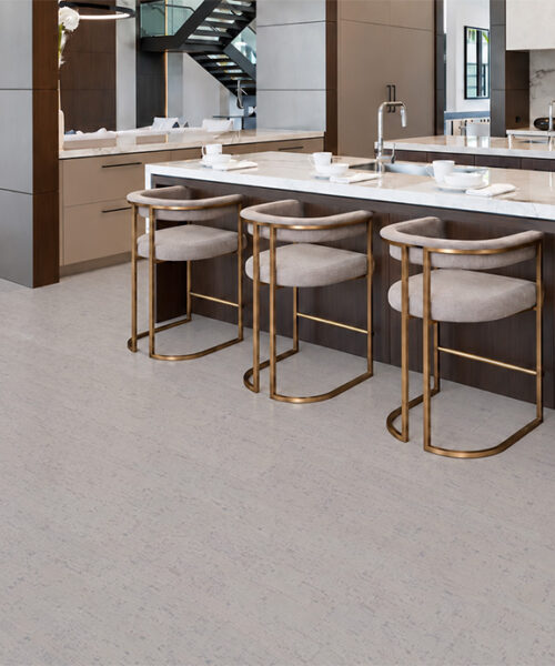 1. Bleached Birch 12mm floating cork flooring complements a waterfall marble island and brass kitchen stools.