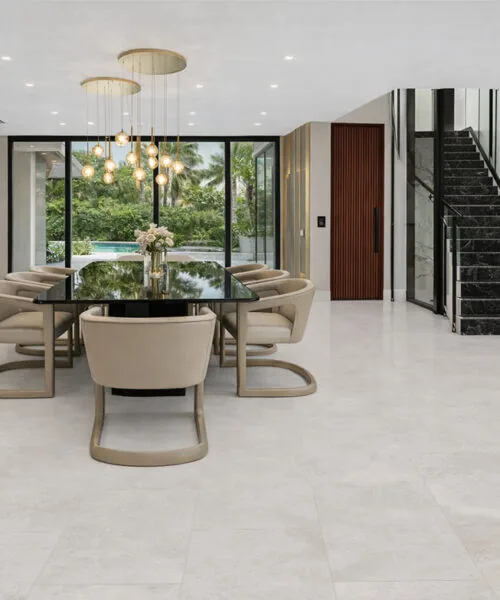 Bright Stone - 19/64&Quot; (7.5Mm) - Swiss Techslate (Mbrst7.5) Bright Stone Techslate Flooring Displays Subtle Gray Variation In A Modern Dining Room With Upholstered Chairs, A Black Table, And Glass Doors.