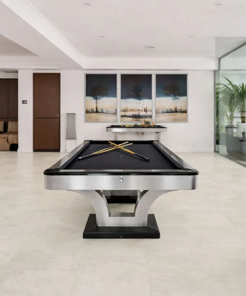 Bright Stone - 19/64&Quot; (7.5Mm) - Swiss Techslate (Mbrst7.5) Bright Stone Stone-Look Flooring Extends Across A Modern Entertainment Room Beneath A Billiard Table, With Large Rectangular Panels In A Staggered Layout.