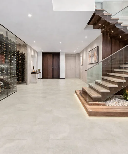 Bright Stone - 19/64&Quot; (7.5Mm) - Swiss Techslate (Mbrst7.5) Bright Stone Techslate Flooring Displays Subtle Gray Variation In A Modern Dining Room With Upholstered Chairs, A Black Table, And Glass Doors.