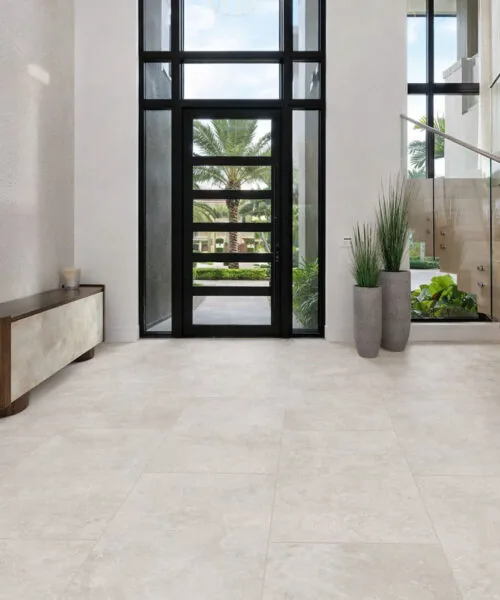 Bright Stone - 19/64&Quot; (7.5Mm) - Swiss Techslate (Mbrst7.5) Bright Stone Swiss Techslate Flooring Shows A Pale Gray Stone-Look Surface With Subtle Mineral Variation In A Contemporary Bathroom With A Freestanding Tub.