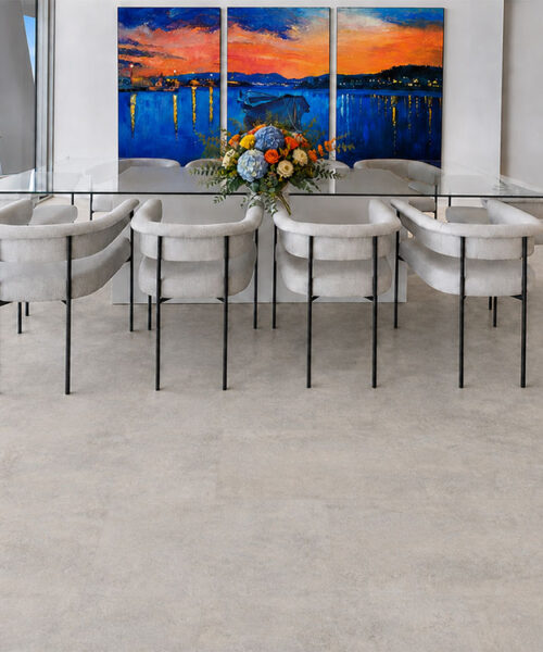 Bris Stone Pale Gray Stone-Look Cork Flooring Surrounds A Waterfront Dining Table Beneath Colorful Artwork.