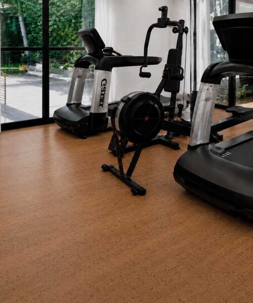 Cherry Line natural cork floating flooring in a bright home gym with treadmills and exercise equipment.