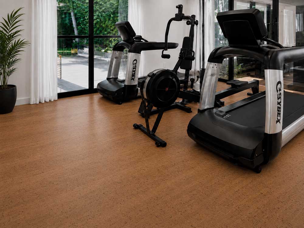 Cherry Line - 7/16&Quot; (11Mm) - Swiss Real Cork Floating (Fchl11) Cherry Line Natural Cork Floating Flooring In A Bright Home Gym With Treadmills And Exercise Equipment.
