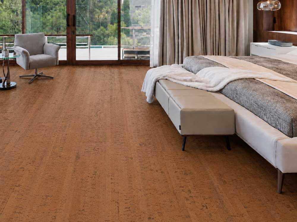 Cherry Line - 7/16&Quot; (11Mm) - Swiss Real Cork Floating (Fchl11) Cherry Line Reddish-Brown Cork Floor Planks In A Modern Bedroom With An Upholstered Bed And Armchair.