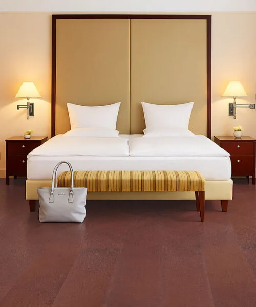 Chestnut – 3/8” (9.5Mm) – Swiss Leather Flooring (Lchsnt9.5) Chestnut Swiss Leather Flooring In A Hotel Style Bedroom With Golden Headboard And Striped Bench