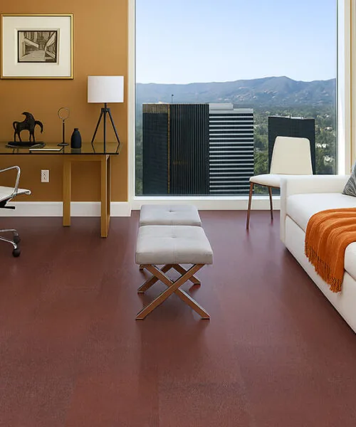 chestnut swiss leather flooring in a lounge room with white sofa orange throw and city view