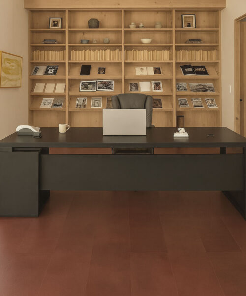 Chestnut Swiss Leather Flooring In A Contemporary Office With Black Desk And Wood Bookshelves
