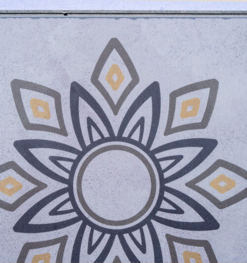 Classic Porcelain Swiss TechSlate flooring featuring a decorative floral medallion pattern inspired by traditional porcelain and cement tiles in soft gray and gold tones.