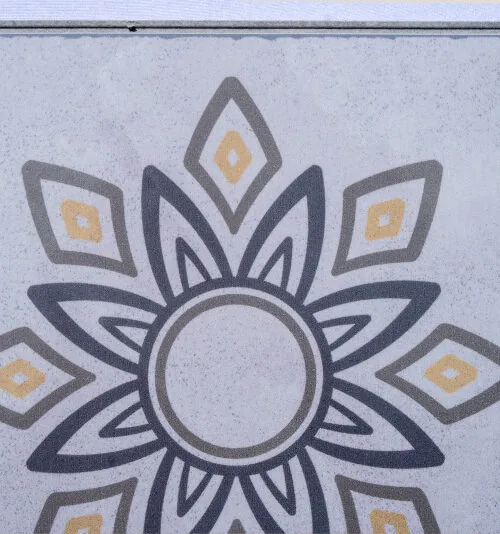 Classic Porcelain Swiss TechSlate flooring featuring a decorative floral medallion pattern inspired by traditional porcelain and cement tiles in soft gray and gold tones.