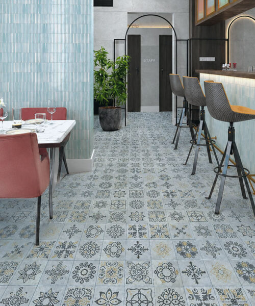 Classic Porcelain Swiss Techslate Flooring In Soft Gray Features Ornate Floral Motifs Across A Stylish Restaurant Dining And Cocktail Bar.