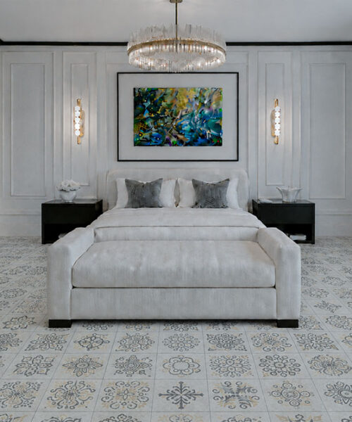 Classic Porcelain Techslate Flooring In Light Gray Displays Delicate Floral Medallions Throughout A Refined Bedroom With White Furnishings And Fireplace.