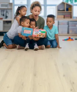 Children Reading Together On Como White Oak Swiss Cork Design Flooring, Showing Comfort And Softness Perfect For Playrooms Or Daycares. Daycare