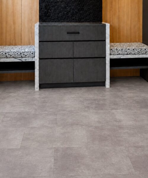 Copperstone Gray Natural Composite Click-Lock Flooring Complements A Modern Entryway With Built-In Benches And Dark Cabinetry.