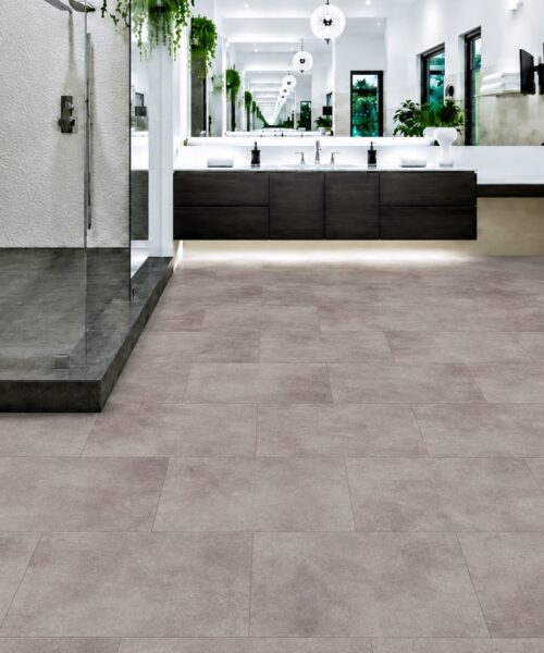Copperstone Gray Waterproof Natural Composite Flooring Covers A Spacious Modern Bathroom With A Glass Shower And Freestanding Tub.