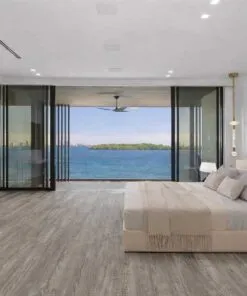 Earthy Pine Swiss Real Linoleum Waterproof Flooring In A Luxury Bedroom With Ocean View, Ideal For Commercial And Hotel Interiors.