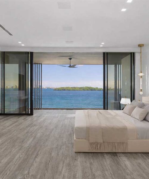 Earthy Pine Swiss Real Linoleum Waterproof Flooring In A Luxury Bedroom With Ocean View, Ideal For Commercial And Hotel Interiors.