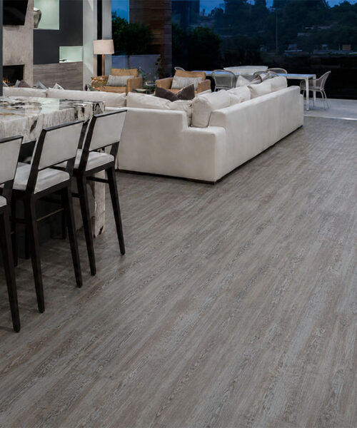 Earthy Pine Waterproof Natural Composite Flooring With Weathered Gray Pine Grain Throughout An Open-Plan Dining And Living Room.