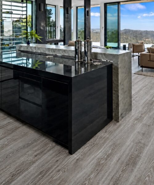 Earthy Pine Natural Composite Click-Lock Flooring With Gray Pine-Look Planks In A Modern Kitchen And Living Area.