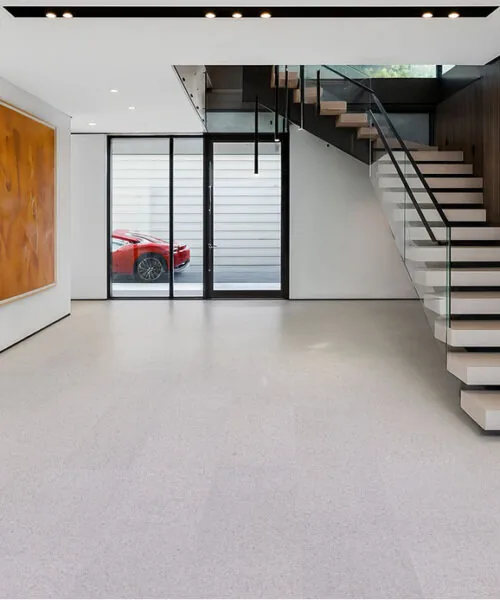 Grano - 25/64&Quot; (10Mm) - Cork Floating (Fgra10) Contemporary Entryway With Floating Staircase, Glass Railing, And Light Grano Cork Flooring Enhancing The Spacious Modern Aesthetic.