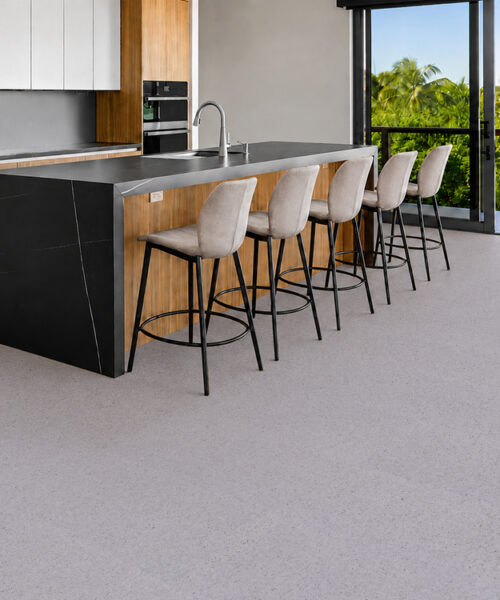 White Grano 10Mm Cork Floating Flooring With Speckled Grain Surrounds A Kitchen Island And Bar Stools.