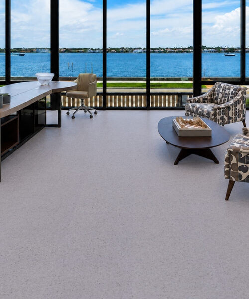 Speckled White Grano 10Mm Cork Floating Flooring Spans A Waterfront Office With Patterned Lounge Chairs.