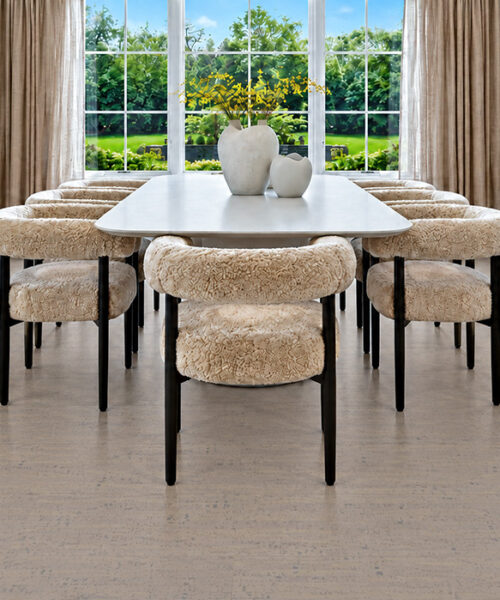Gray Bamboo warm gray linear-grain cork flooring complements boucle dining chairs and large garden windows.