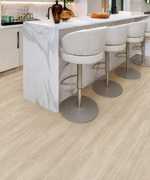 Hamilton - 7/16&Quot; (11Mm) - Swiss Design Cork Floating (Fham11) Hamilton Light Gray Cork Floating Floor In A Modern Kitchen With A Marble Island And Bar Stools