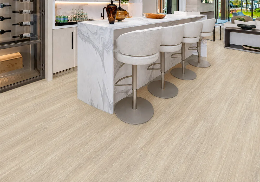 Hamilton - 7/16&Quot; (11Mm) - Swiss Design Cork Floating (Fham11) Hamilton Light Gray Cork Floating Floor In A Modern Kitchen With A Marble Island And Bar Stools