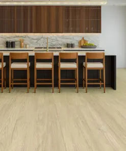Elegant Kitchen With Hamilton Swiss Cork Floating Flooring In A Light Oak Finish, Complemented By A Marble Island, Wood Cabinetry, And Matching Bar Stools In A Bright Open-Concept Layout