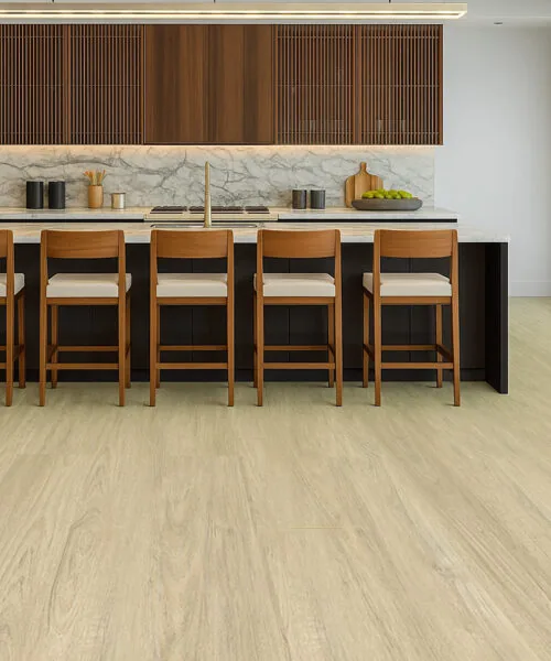 Hamilton - 7/16&Quot; (11Mm) - Swiss Design Cork Floating (Fham11) Elegant Kitchen With Hamilton Swiss Cork Floating Flooring In A Light Oak Finish, Complemented By A Marble Island, Wood Cabinetry, And Matching Bar Stools In A Bright Open-Concept Layout