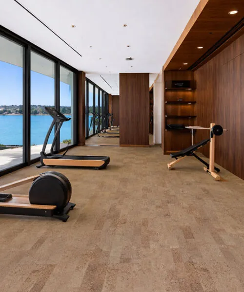 Eco-friendly hazel cork flooring in a bright room with indoor-outdoor view gym