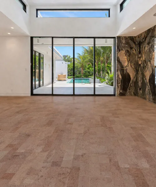 Hazel Cork Flooring In A Modern Living Room With Large Windows And Natural Light