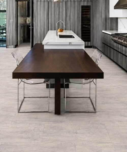 Ivory Concrete - 3/8&Quot; (9.5Mm) - Forna Natural Composite Flooring With Waterproof Hydrowood Core (Nicon9.5) Ivory Concrete Natural Composite Flooring With A Pale Concrete-Look Pattern In A Modern Kitchen And Dining Area.
