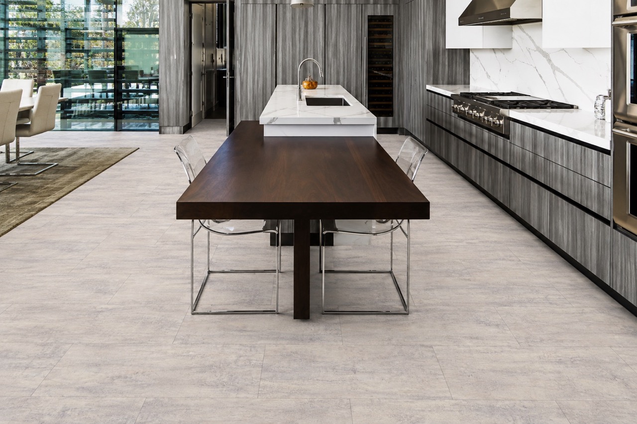 Ivory Concrete - 3/8&Quot; (9.5Mm) - Forna Natural Composite Flooring With Waterproof Hydrowood Core (Nicon9.5) Ivory Concrete Natural Composite Flooring With A Pale Concrete-Look Pattern In A Modern Kitchen And Dining Area.
