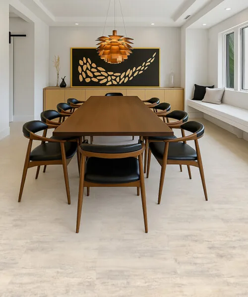Ivory Concrete Forna Natural Composite Flooring in a contemporary dining room, featuring a light concrete finish that is durable and waterproof for basement use.
